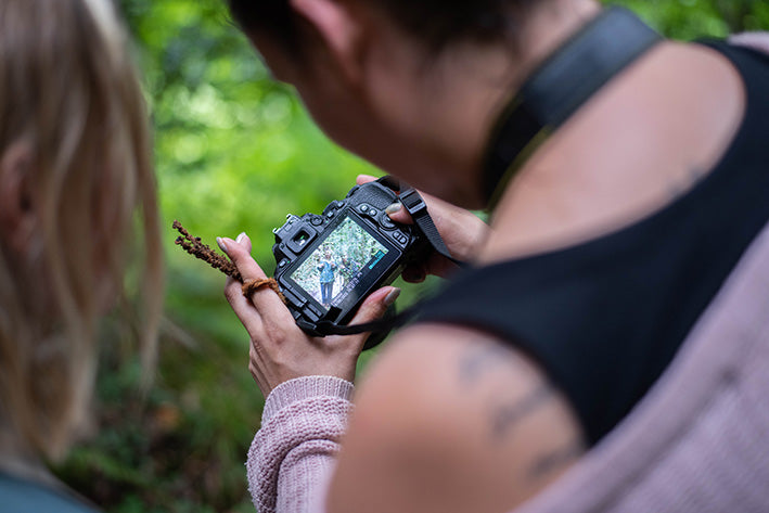 Woman looking at camera viewfinder