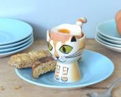Ginger cat egg cup with toast and boiled egg