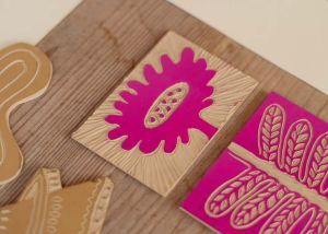 Linocut of plant with pink ink