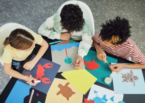 Image shows three young people doing art activities