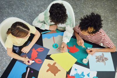 Image shows three young people doing art activities