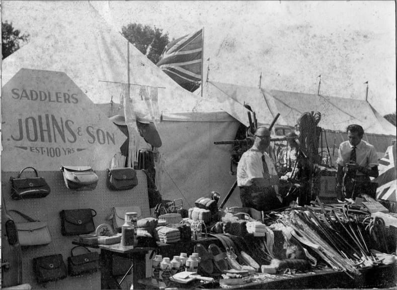 Black and white photograph showing Johns & Sons saddlers stall.