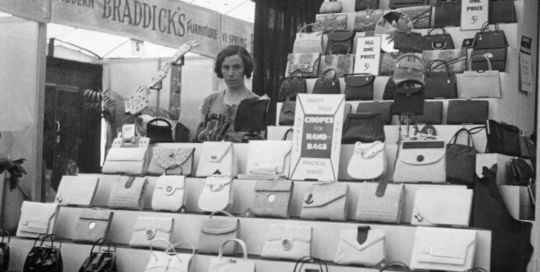 Black and white photograph of leather stall with ladies handbags