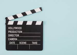 Film clapperboard on light blue background