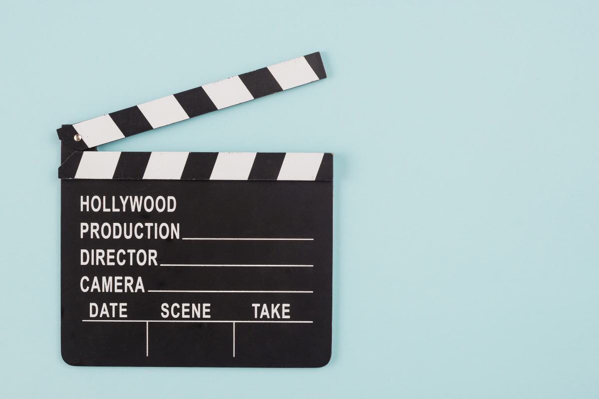 Film clapperboard on light blue background