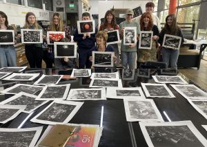Artist Emma Stibbon and BYC members show off their monoprints