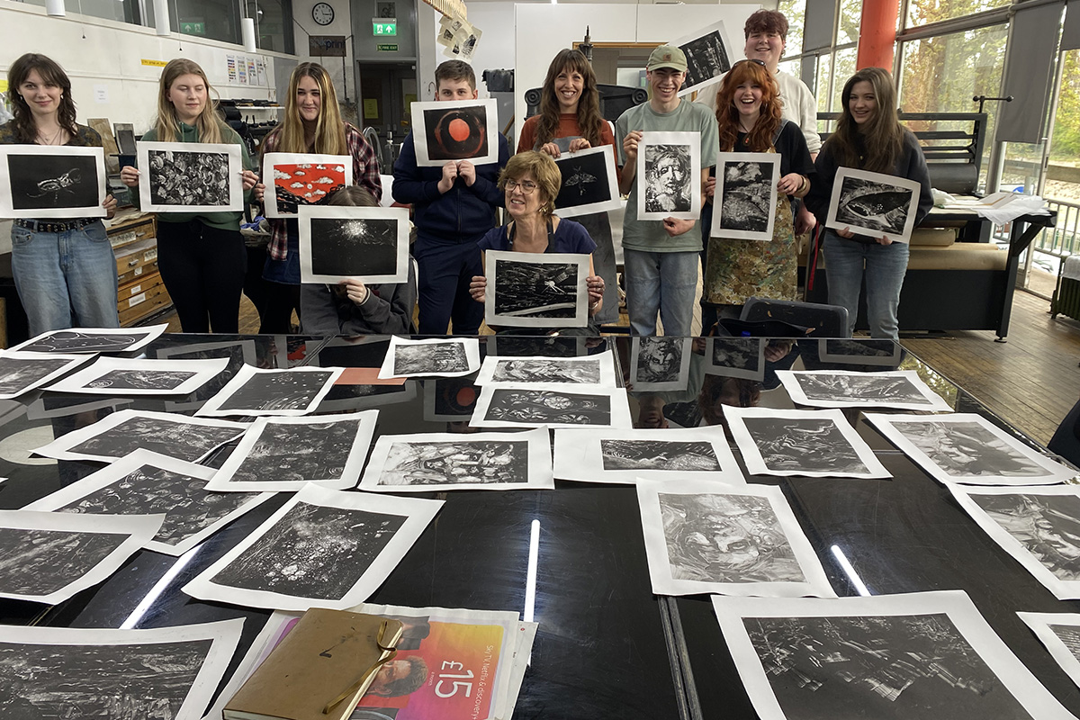 Artist Emma Stibbon and BYC members show off their monoprints