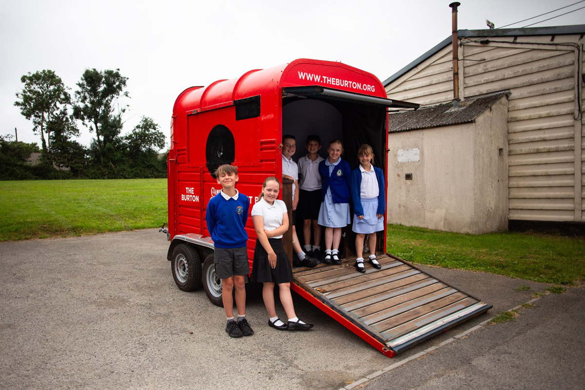 Image shows children from a rural school standing outside The Burton Art Box