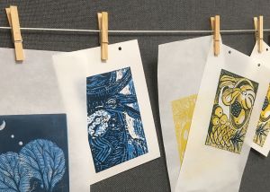Image shows linoprints drying on a line