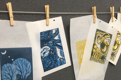 Image shows linoprints drying on a line