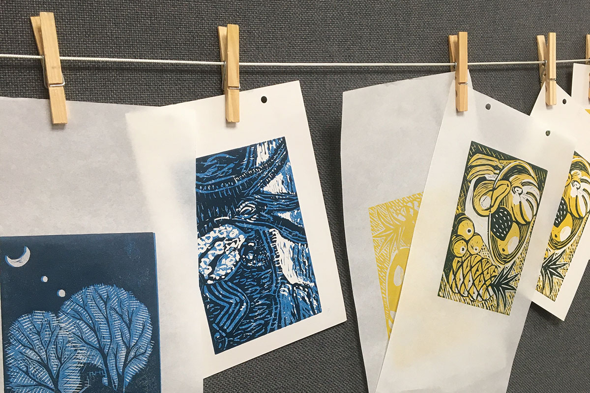 Image shows linoprints drying on a line