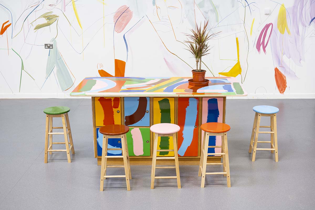Colourful table and five stools with colourful background