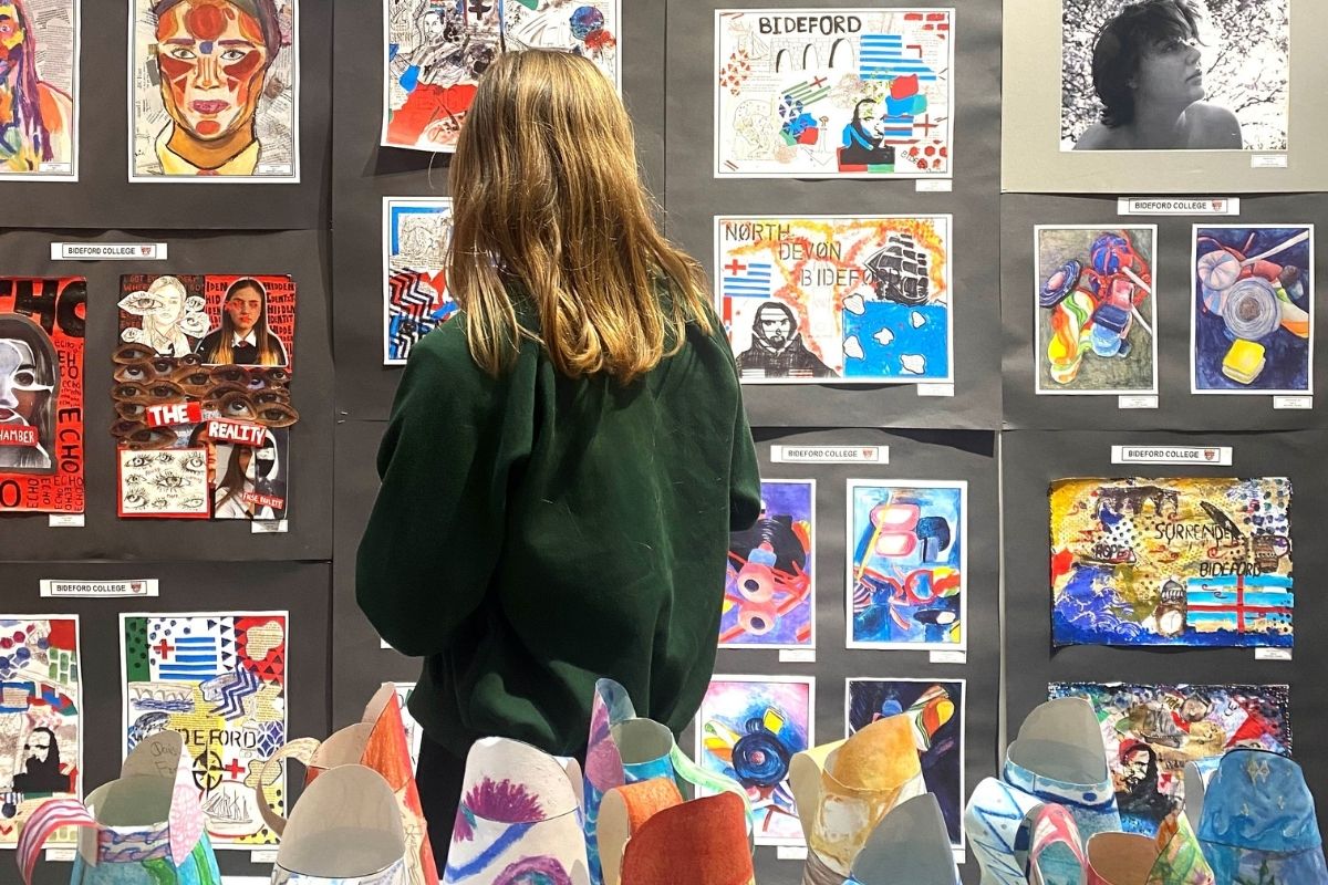 Image of a girl at the Schools Exhibition 2025, looking at artwork on the walls