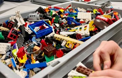 Hand playing with Lego bricks